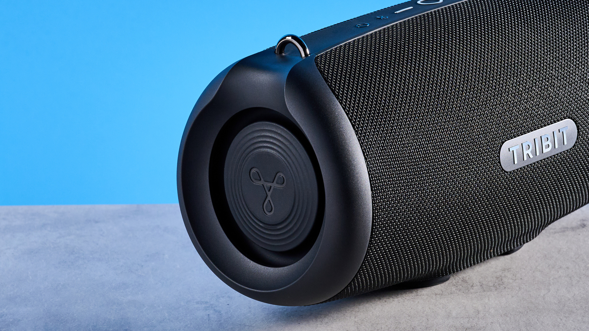 Tribit StormBox Lava Bluetooth Speaker photographed in front of a blue background.