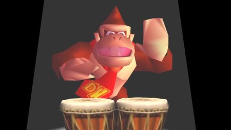 A screenshot of Donkey Kong 64 via DK64 Rekongpiled. Donkey Kong stands in a spotlight while playing his bongos.