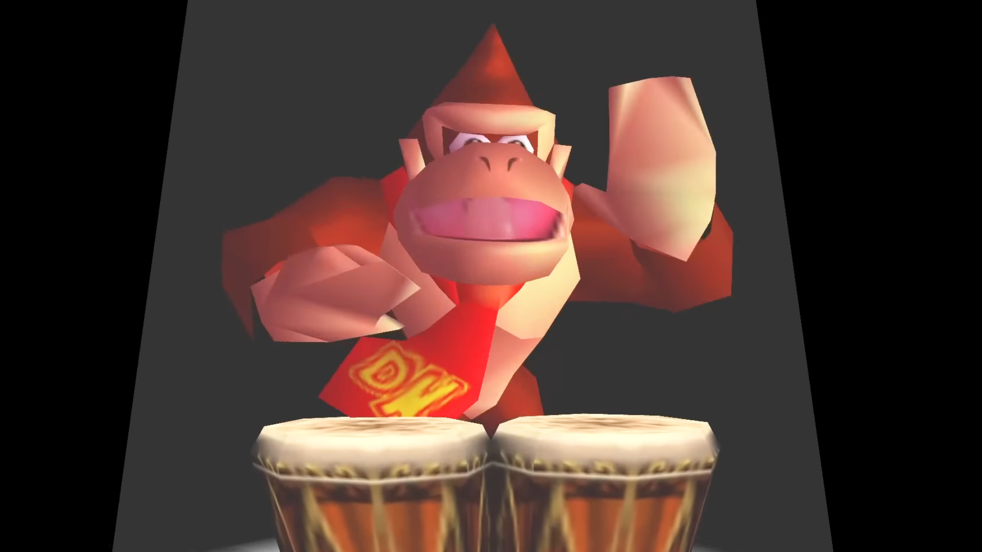 A screenshot of Donkey Kong 64 via DK64 Rekongpiled. Donkey Kong stands in a spotlight while playing his bongos.