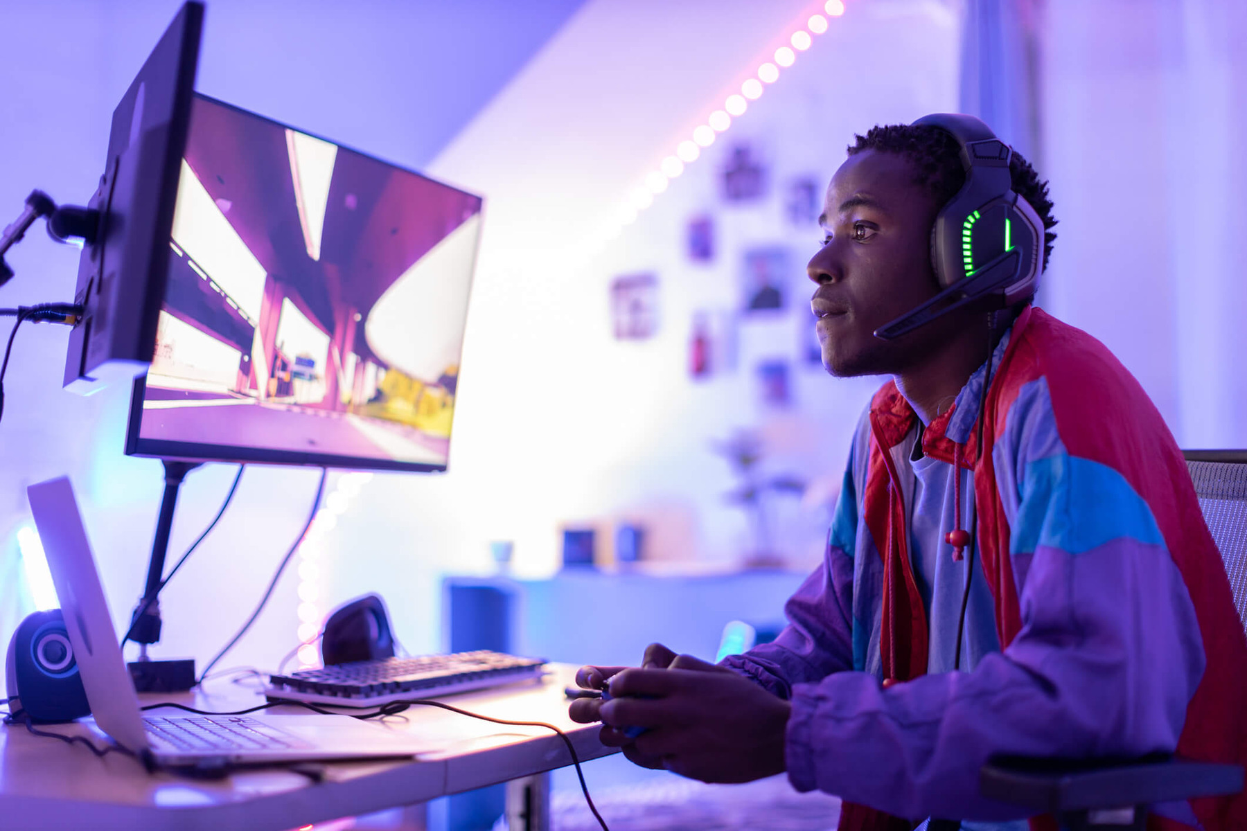 A young male gamer at his desk