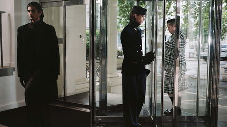 Three men in A/W 2022 menswear in revolving office door