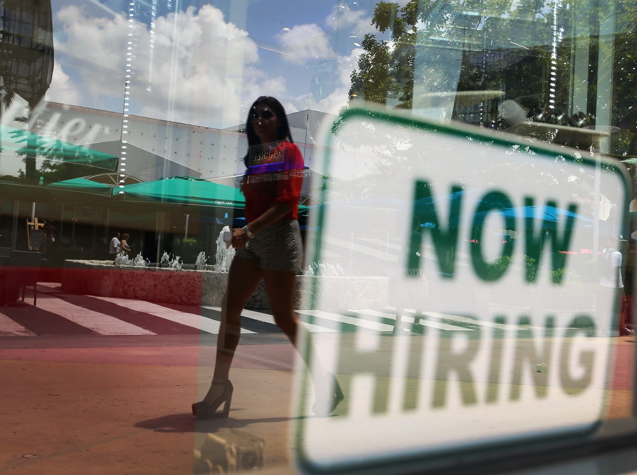 A &amp;quot;now hiring&amp;quot; sign at a storefront