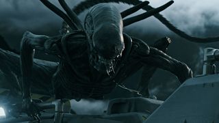 A xenomorph bares its teeth on top of a spaceship in Alien: Covenant