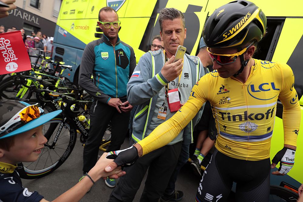 Peter Sagan (Tinkoff) wears yellow and shakes hands with his fans