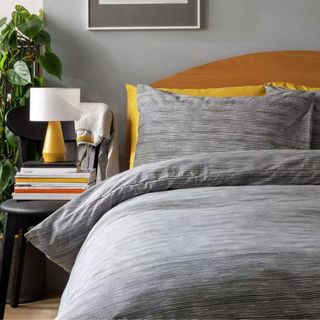 Grey striped bedding in a bedroom