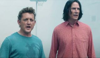 Bill & Ted Face The Music Alex Winter and Keanu Reeves standing in the prison yard, worried