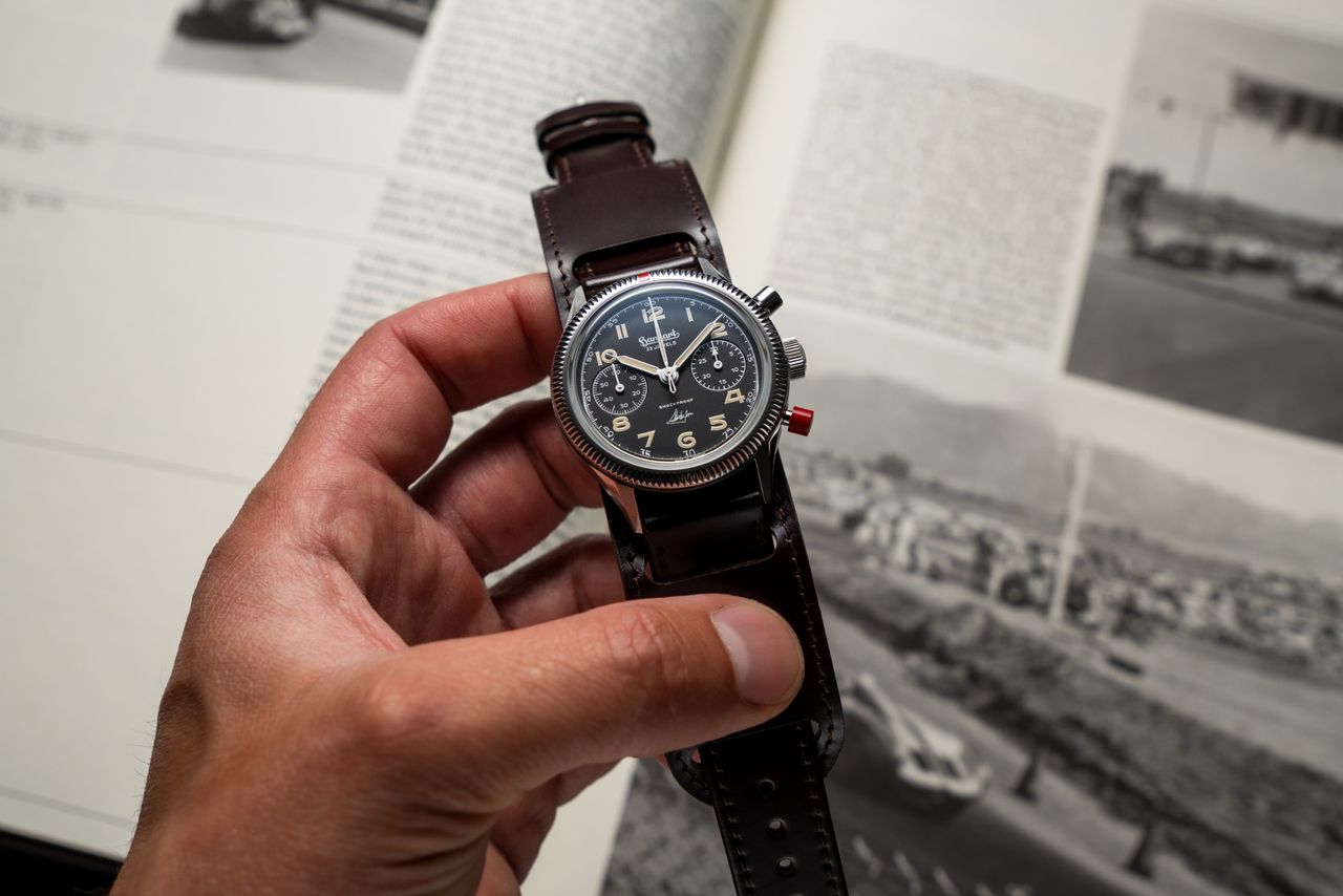 A watch with brown strap and a blue dial