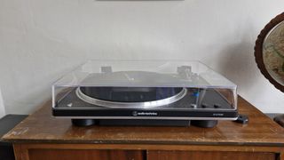 Audio-Technica AT-LP70XBT on a wooden table with the dust cover down