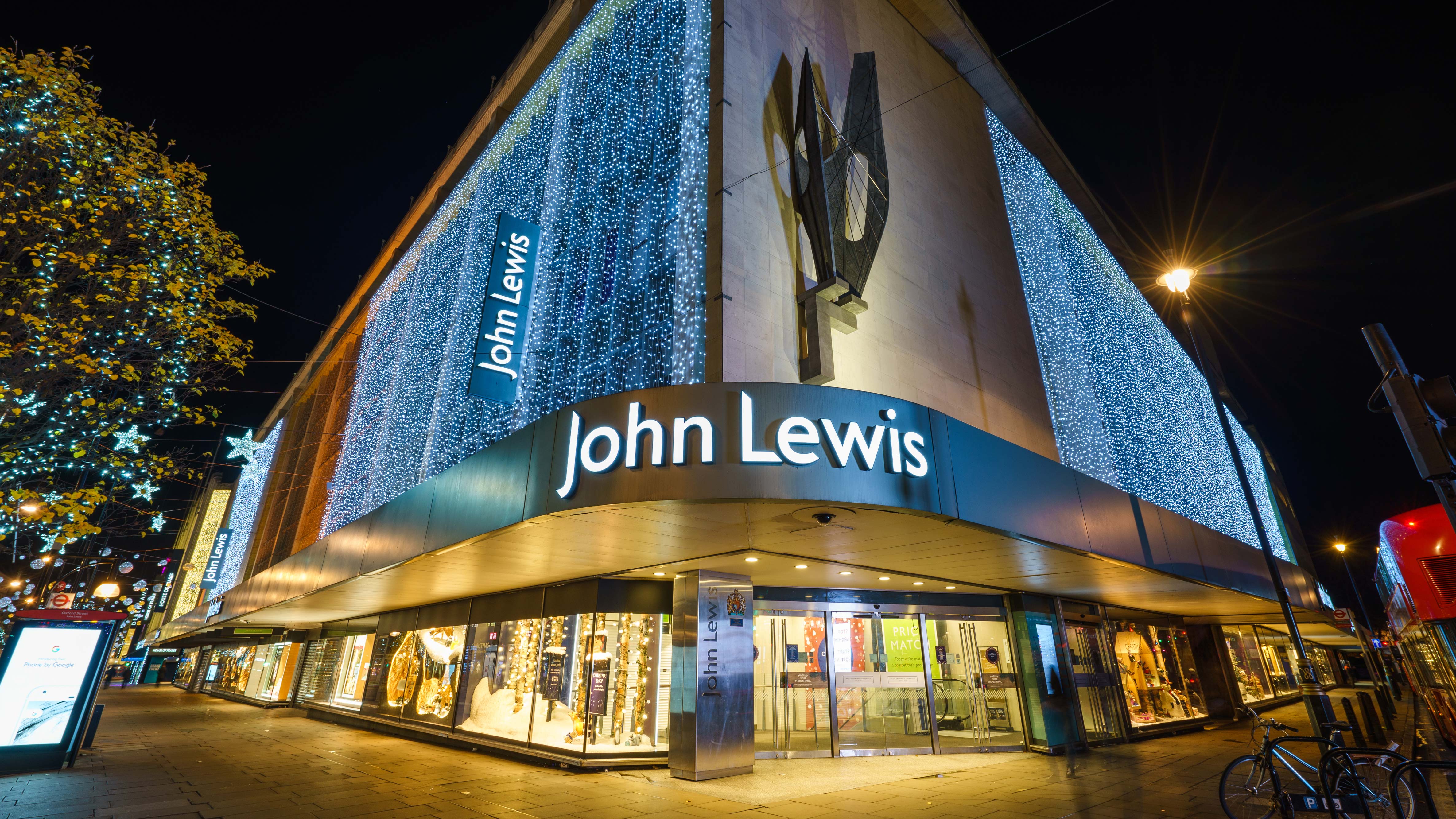 A John Lewis storefront lit up with lots of small lights