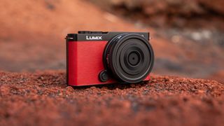 Panasonic Lumix S 26mm f/8 lens attached to a camera sat on some red sandstone