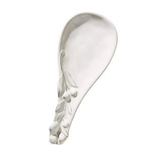 A white ceramic spoon rest with an olive branch motif