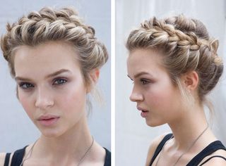 Model hairstyle is intricate braided updo