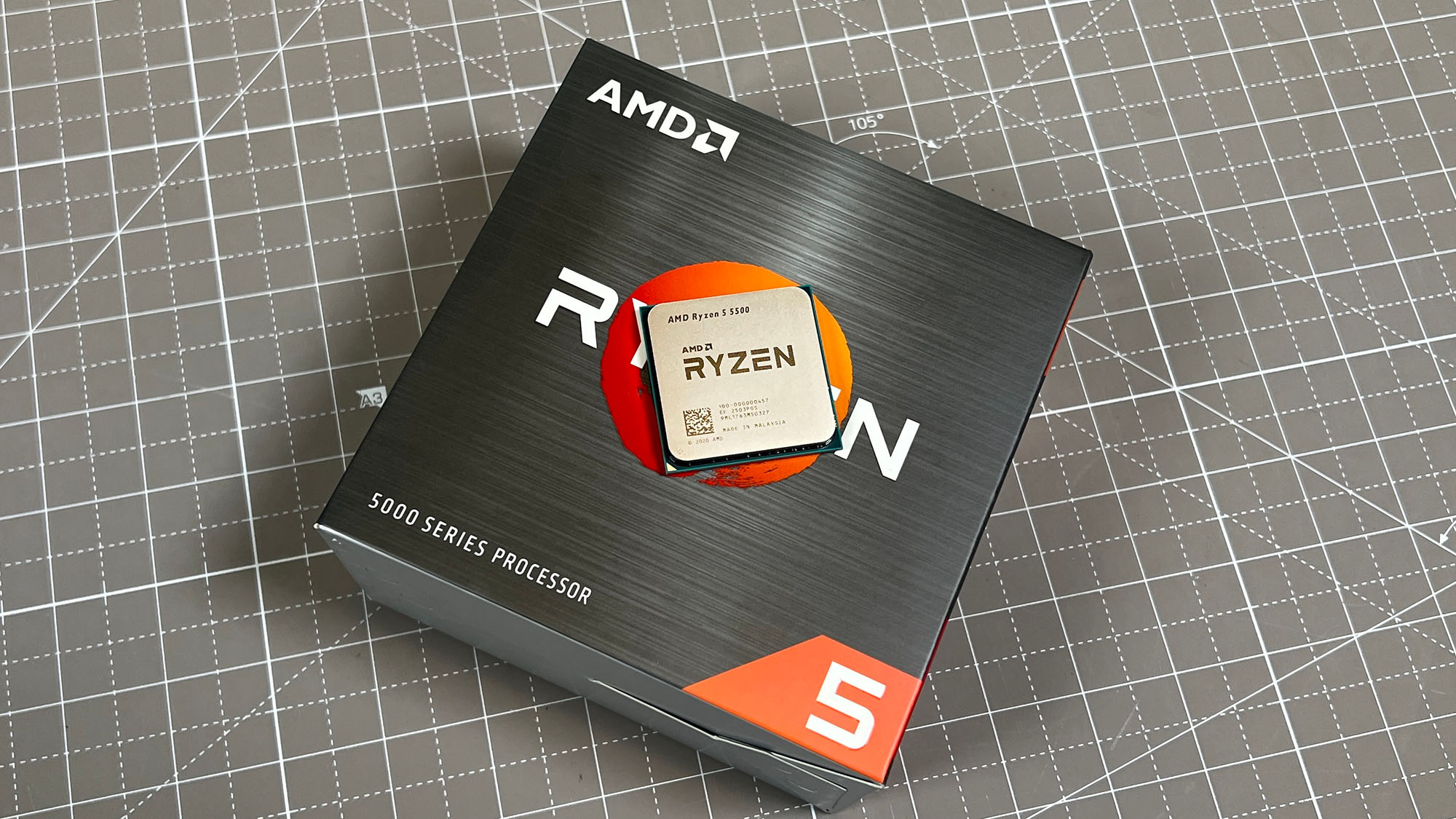 An AMD Ryzen 5 5500 sitting on its retail packaging