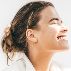 A woman smiling at the sun