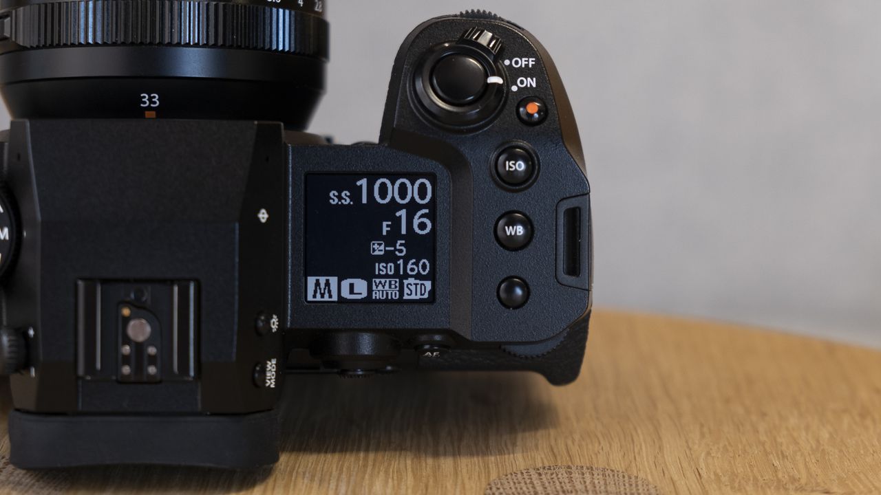 The Fujifilm X-H2S camera on a wooden table
