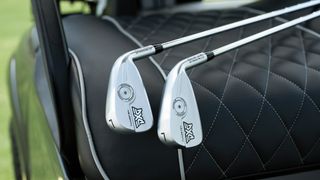 Two PXG irons on a buggy