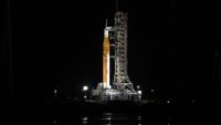 A photo of the Artemis II SLS rocket and Orion spacecraft on a launch pad at the Kennedy Space Center in Cape Canaveral, Florida, at night. 