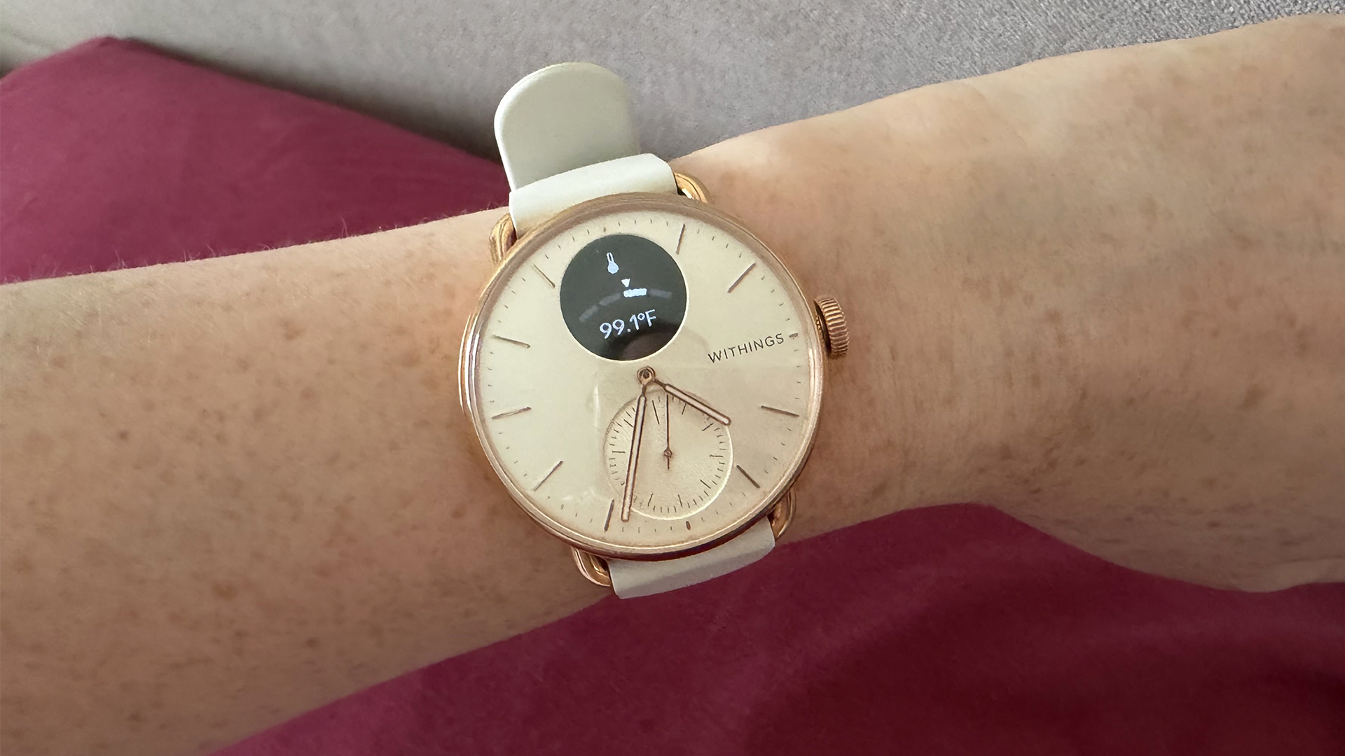 A close up of the Withings ScanWatch 2 on a wrist showing the temperature reading function
