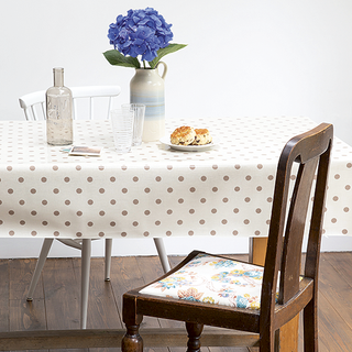 table with dotted pattern table cloth and chairs
