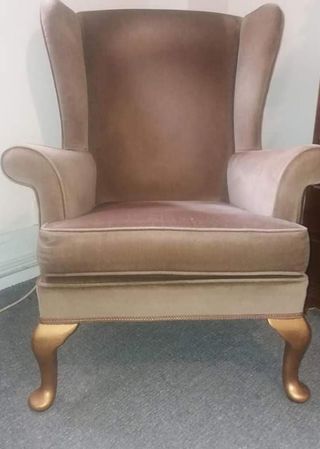 brown armchair with carpet flooring