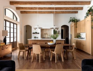 a kitchen with wood cabinets and dining table