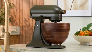 KitchenAid Evergreen Design Series Artisan Tilt-Head 4.7L Stand Mixer with unique Walnut Wooden Bowl on the counter