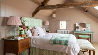 pink and green traditional bedroom with beams