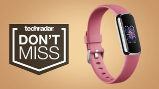 Pink Fitbit Luxe on gold background