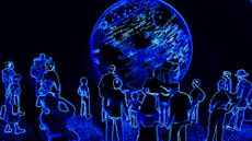 People crowded around a virtual space looking at the Earth 