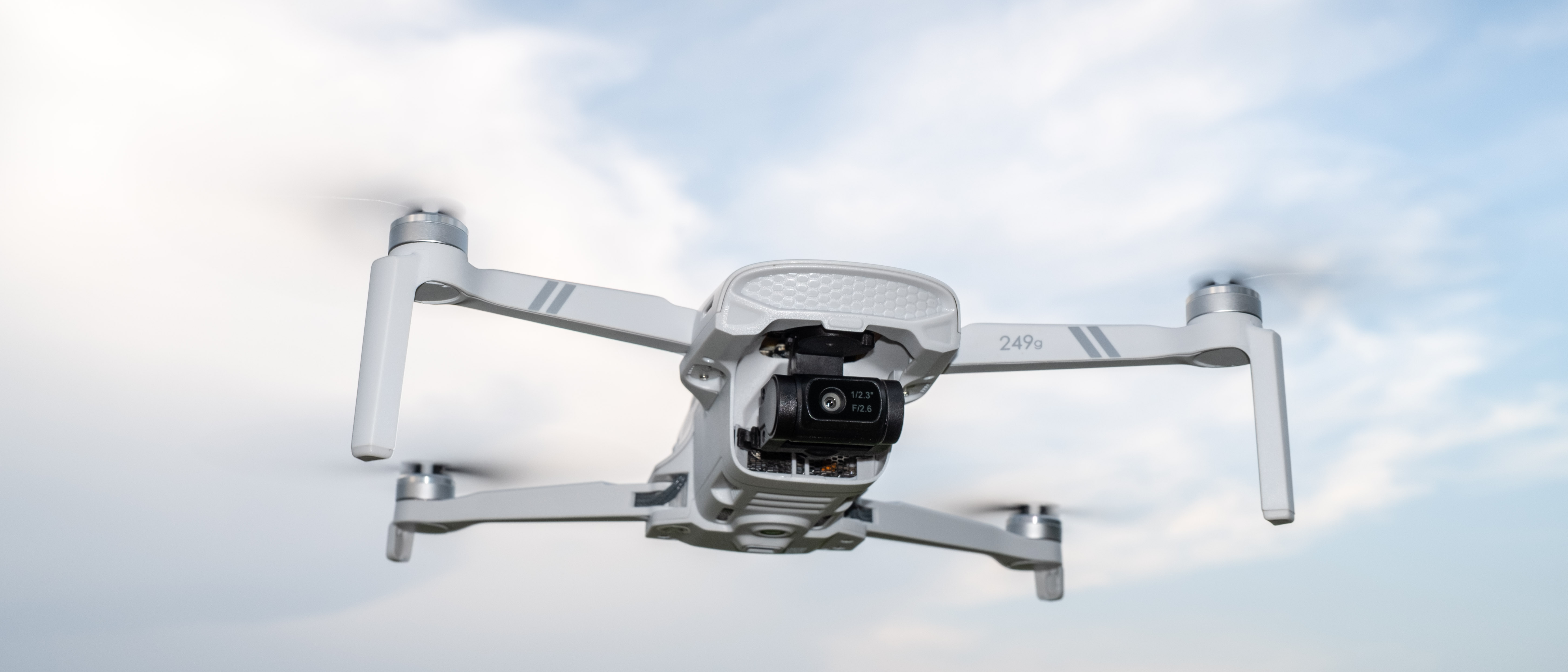 Holy Stone HS900 in flight against a cloudy sky