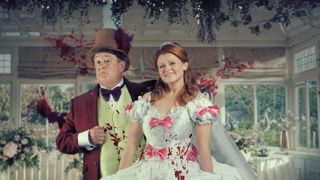 Murder They Hope season 2 - Johnny Vegas and Sian Gibson stand in a conservatory wearing bloodstained wedding clothes as Terry and Gemma.