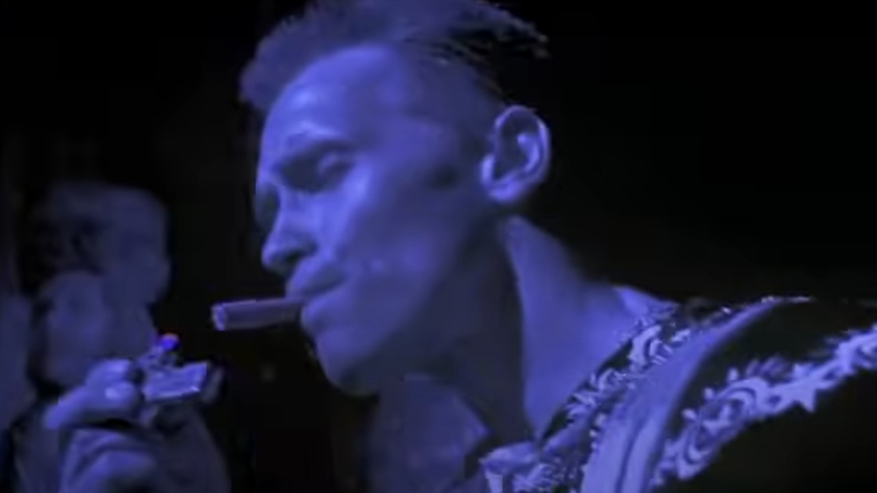 Arnold Schwarzenegger lightning a cigar in Last Action Hero