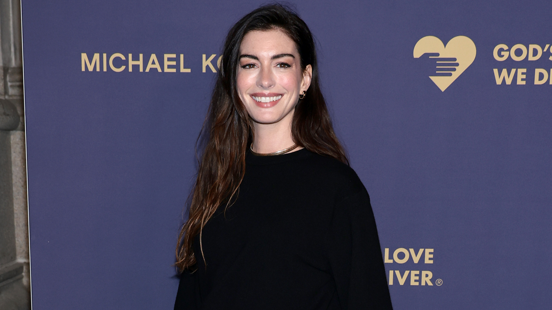 Anne Hathaway arrived at the 2025 Golden Heart Awards wearing all-black Michael Kors, plus the skirt over pants trend
