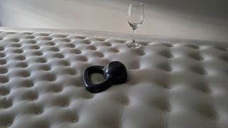 A 10lb weight next to an empty wine glass after testing motion isolation during Cloverlane mattress review
