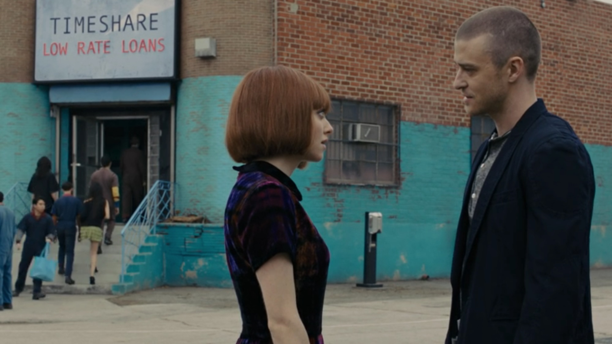 Amanda Seyfried and Justin Timberlake standing outside a Timeshare loan building in In Time