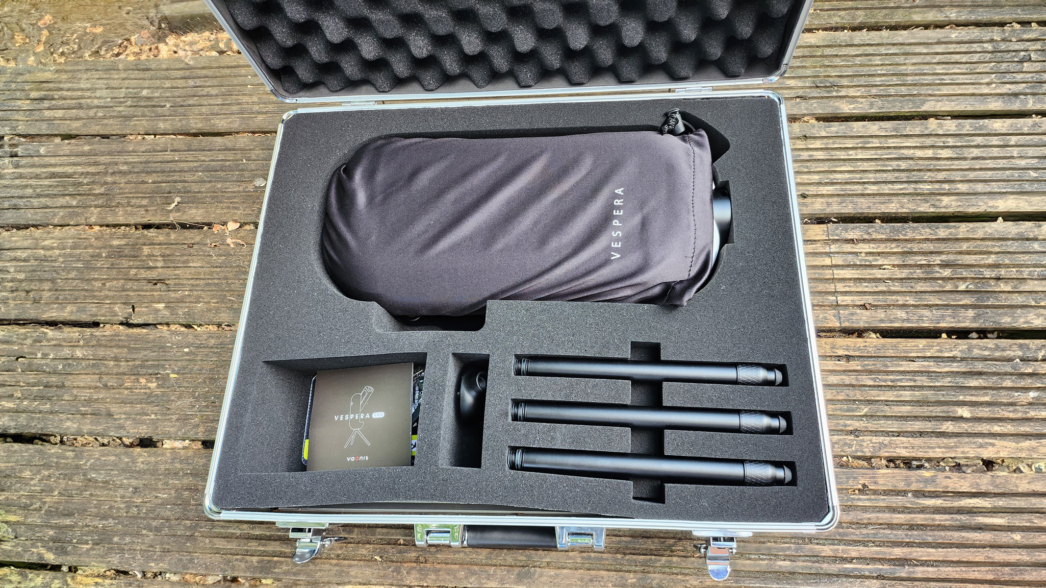 A closeup of inside the Vaonis Vespera Pro carry case showing Vaonis Vespera Pro, tripod parts and instruction booklet.