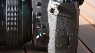 The Pentax K-3 III DSLR, showing the controls on the left side of the camera include image stabilization