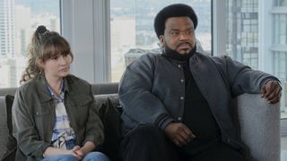 Claudia O'Doherty as Jillian and Craig Robinson as Craig on the couch in Killing It season 2
