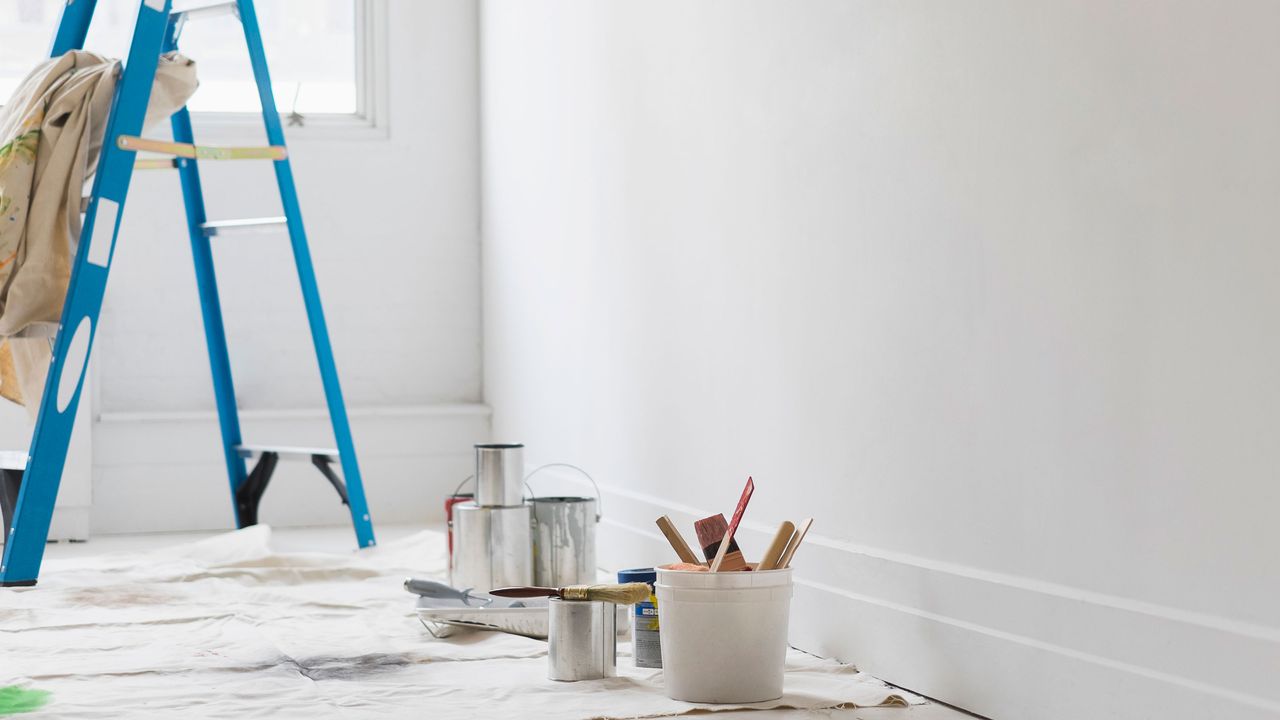 blue ladder in white room being decorated