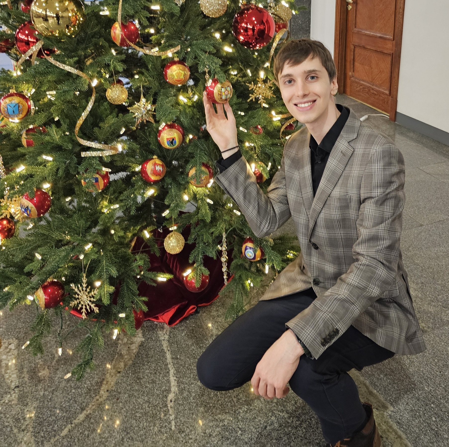 Streamer Xop0 posing next to Christmas tree