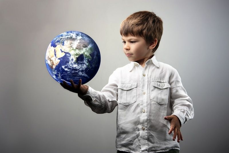 A young boy with a globe.