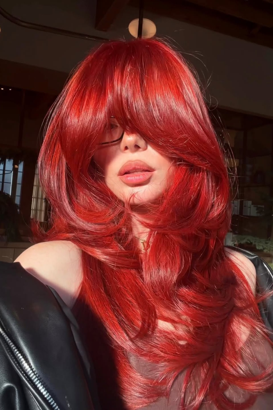 A model with their hair cut in long layers.