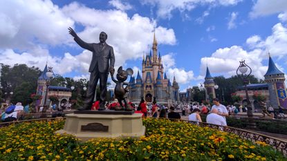 A statue of Walt Disney and Mickey Mouse in Disney World's Magic Kingdom.