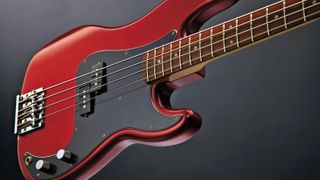 Candy Apple Red Fender P-Bass on dark background