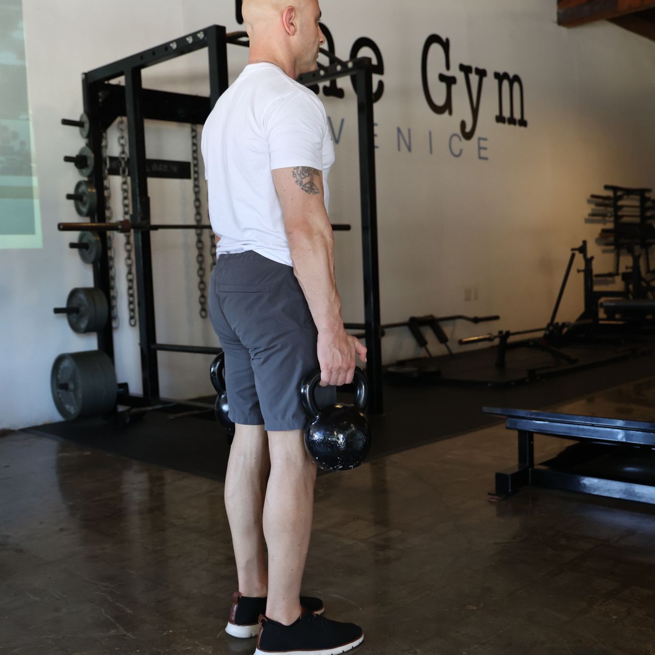 Man exercising in gym with kettlebell
