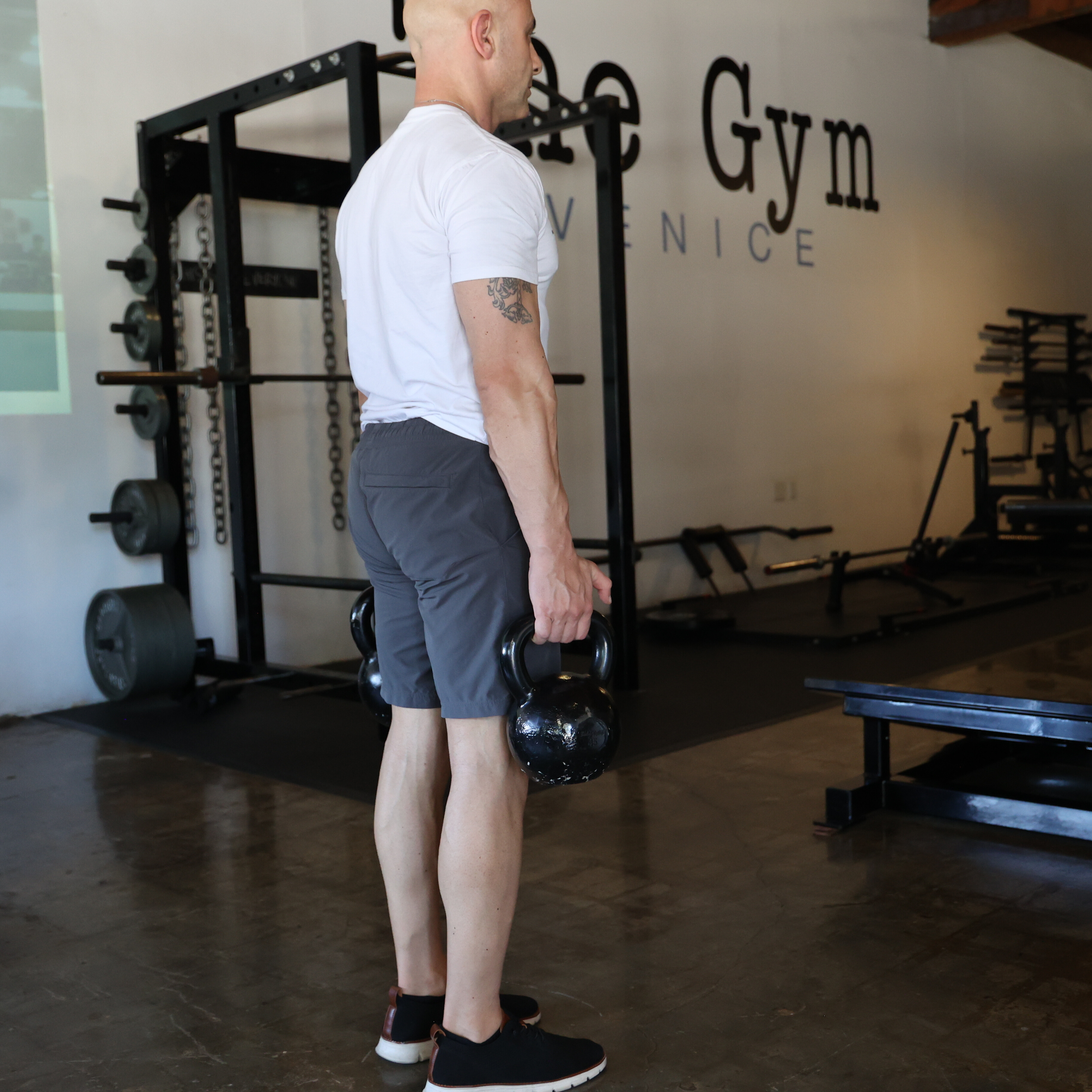 Man exercising in gym with kettlebell