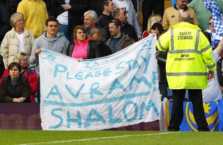 Portsmouth fans hold up a sign which asks manager Avram Grant to stay at the club