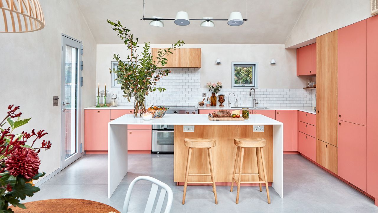 Pink kitchen with white tiles and a contemporary white kitchen island