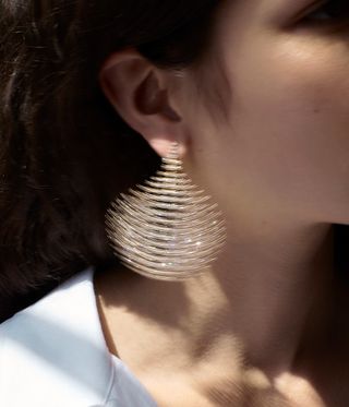 Woman wears earrings by Fernando Jorge