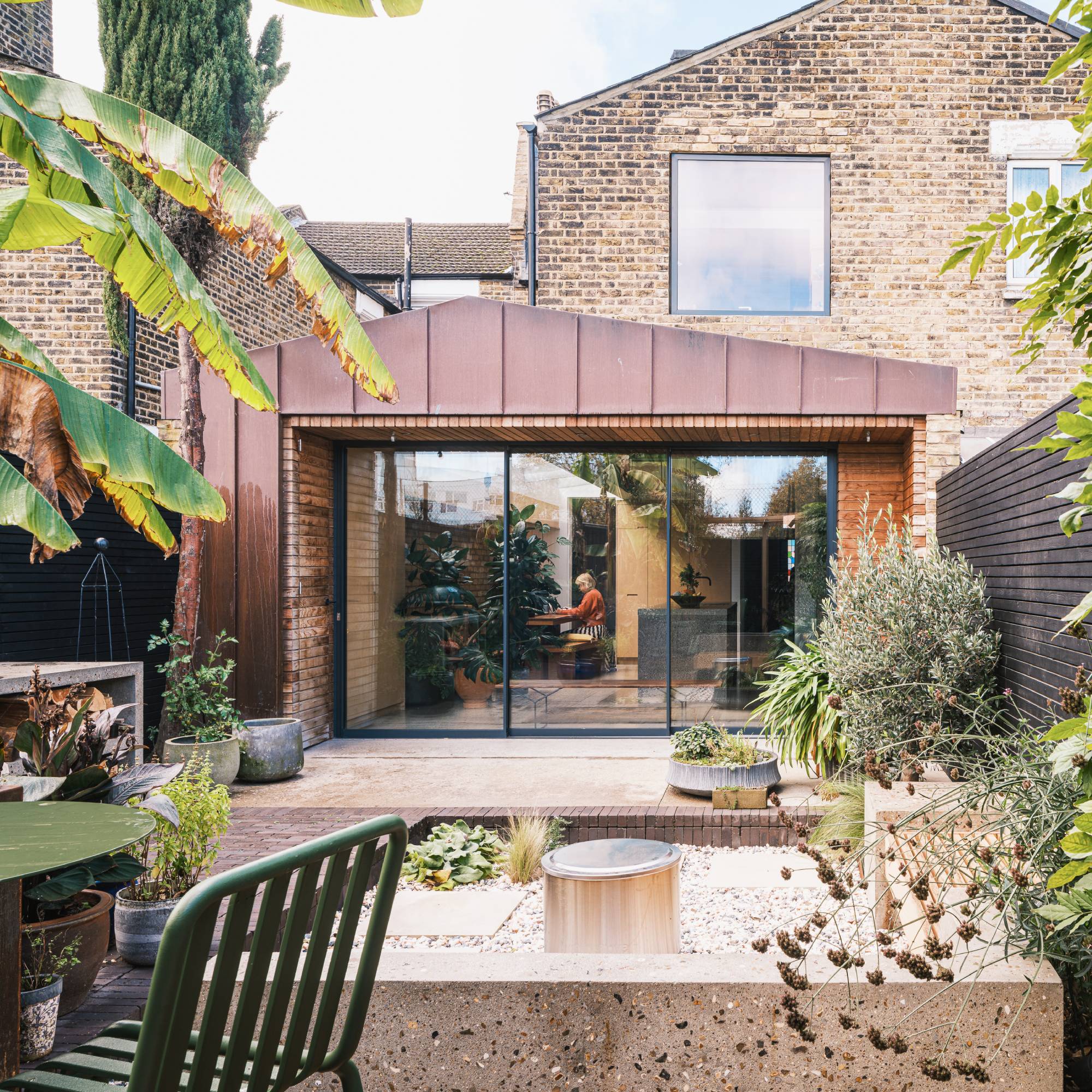 copper cladding on rear extension to terrace house with modern landscaped garden